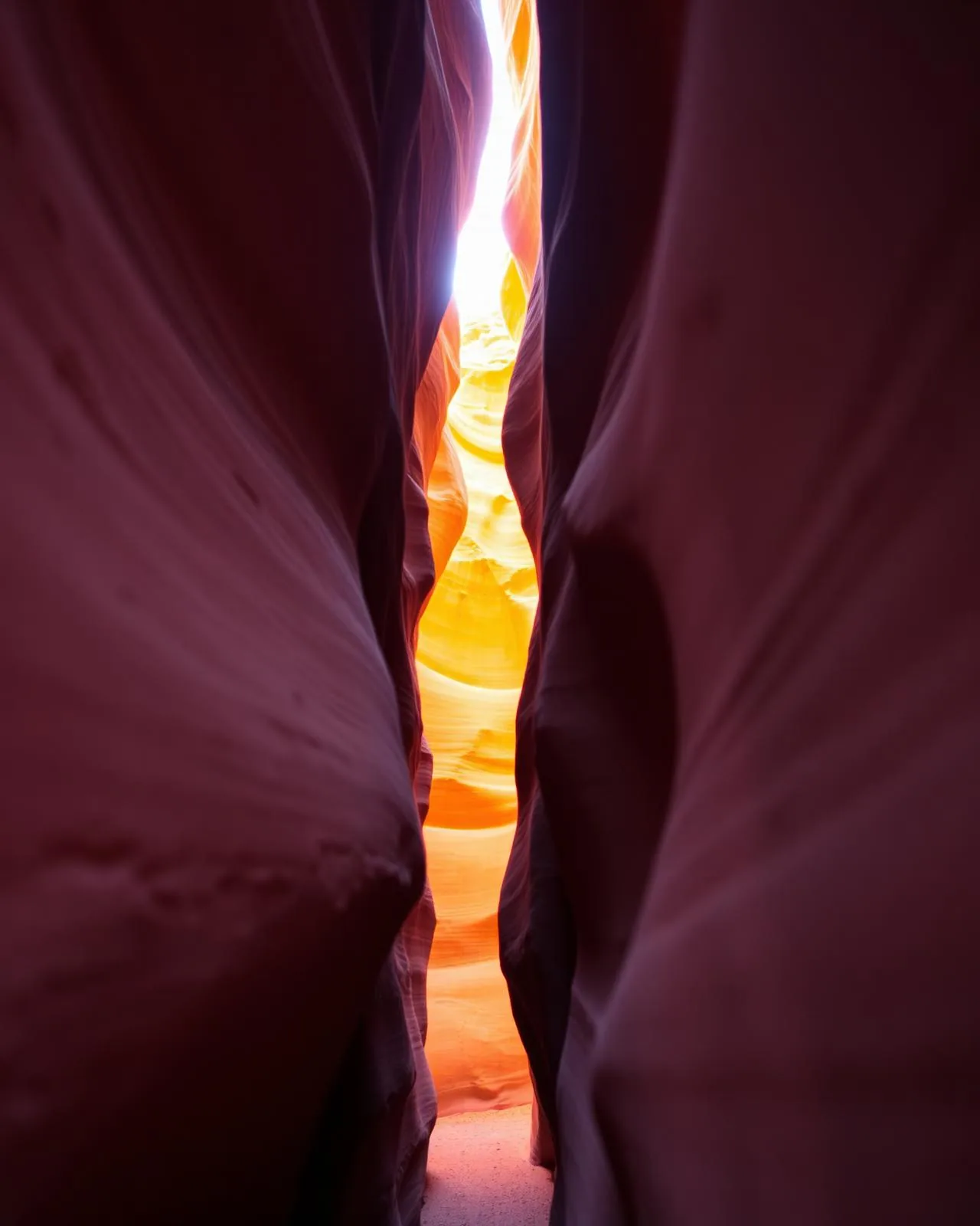 Light pouring down a narrow sandstone canyon